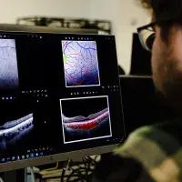Scientist looking at retinal scan