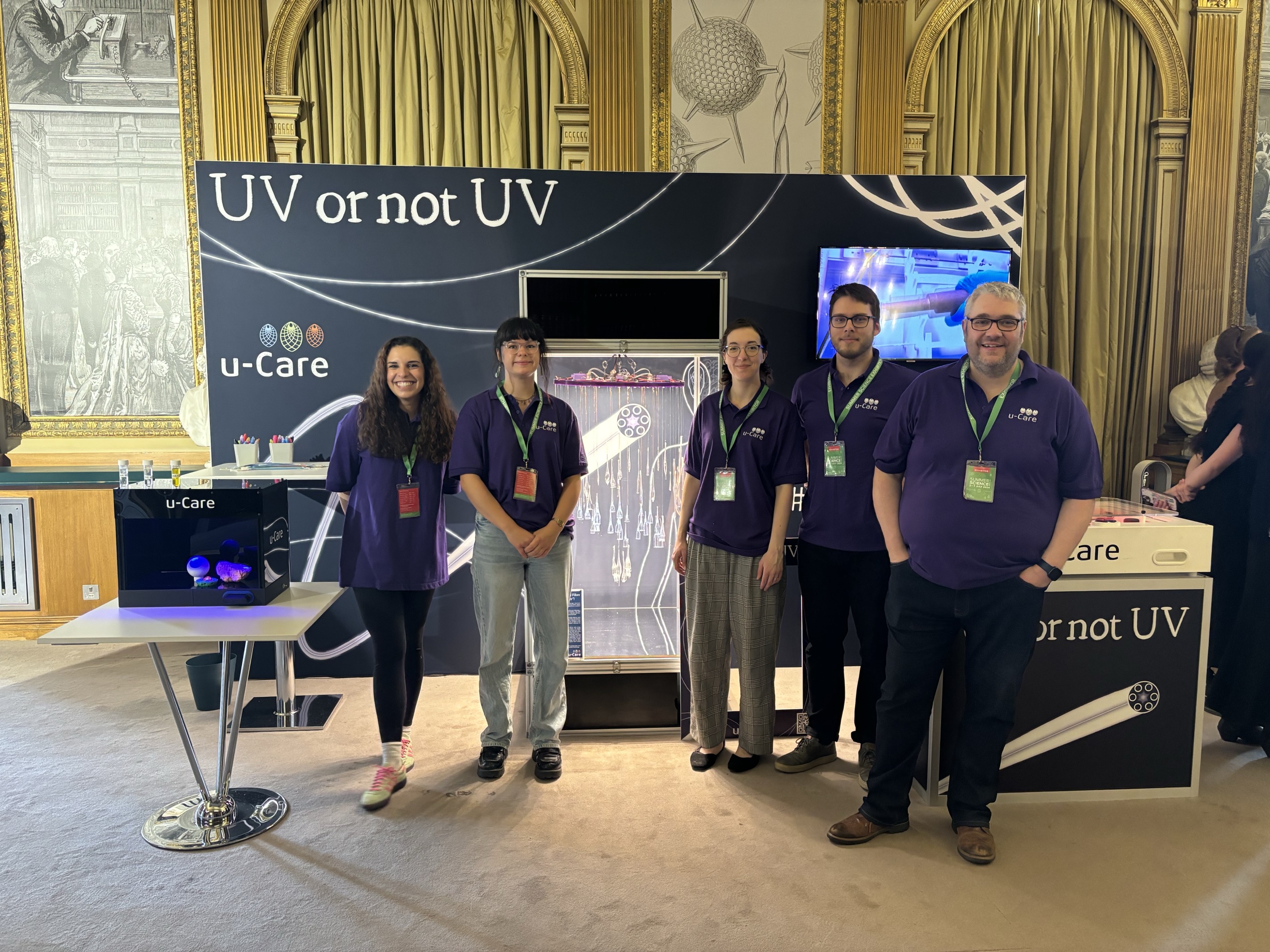 the u-care team of 5 people stand in front of their interactive exhibit
